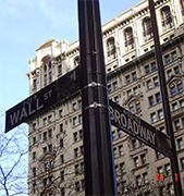 Wall street and NYSE financial centre in downtown New York City Luxurious but unmarket, like a prestigious private club, the Morgan building was nevertheless so well known that when, in 1920, a wagon exploded across the street killing 30 people, it was simply assumed-though never proven that an anarchist bomb had been aimed at the bank. The pockmarks on the bank's wall street facade have been left deliverately unrepaired, and can still be seen today