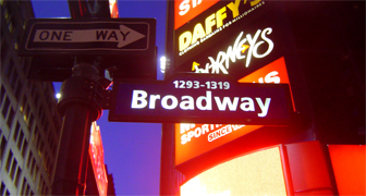 Broadway, as the name implies, is a wide avenue in New York City, and is the oldest north-south main thoroughfare in the city, dating to the first New Amsterdam settlement. The name Broadway is an English translation of the Dutch name, Breede weg. The street is famous as the pinnacle of the American theater industry